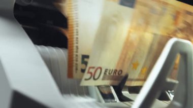 Money counting equipment for paper money calculation Automatic mechanism for bank financial operations. Close up of euro banknotes while being counted