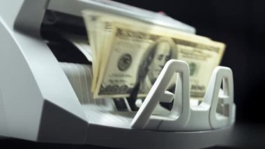 Money counting equipment for paper money calculation. Automatic mechanism bank financial operations. Currency exchange of one hundred usd. Closeup currency counting machine counting dollar bills
