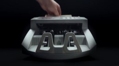 Money counting equipment for paper money calculation. Automatic mechanism bank financial operations. Currency exchange of one hundred usd. Closeup currency counting machine counting dollar bills