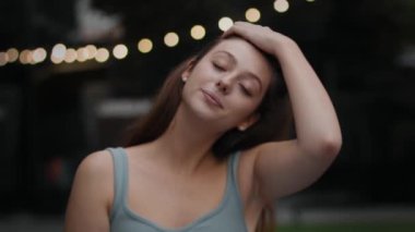 Close-up: attractive girl woman outdoors smiling looking at camera, happy