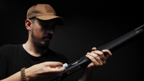 Close Man Black Shirt Black Background Loads Shotgun — Video