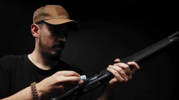 Close Man Black Shirt Black Background Loads Shotgun — Video Stock