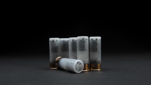 Close Shotgun Shells Table Dark Background One Cartridge Rolled Frame — Stockvideo