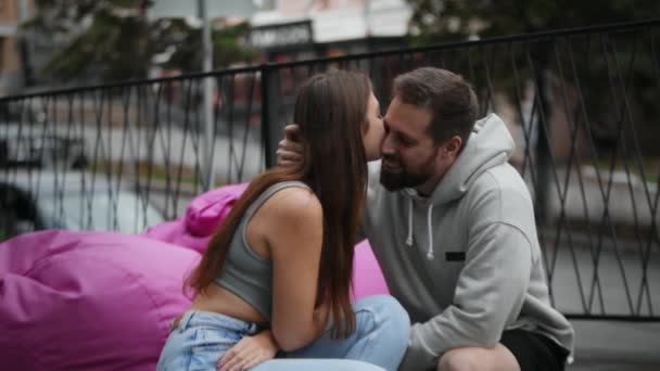 Couple Love Sits Ottoman Terrace Kisses Hugs — Vídeo de Stock