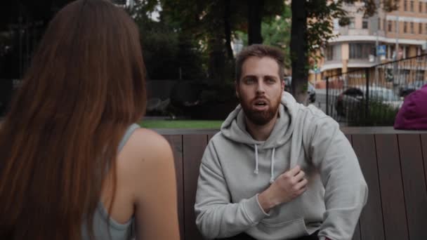 Attractive Man Listening Chatting Girl While Sitting Street — Vídeos de Stock