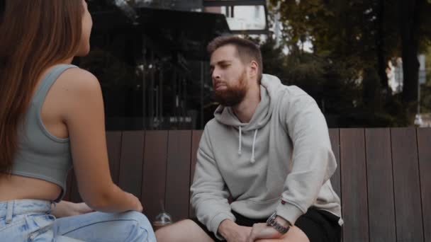 Attractive Man Listening Chatting Girl While Sitting Street — Stockvideo