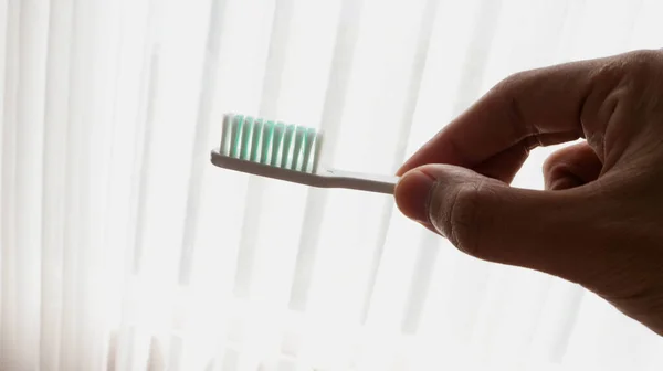 Man Hand Holding White Toothbrush — Photo