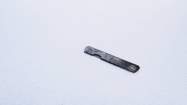 rusty razor blade on a white background