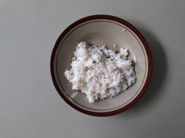 Plate and white rice on a white background