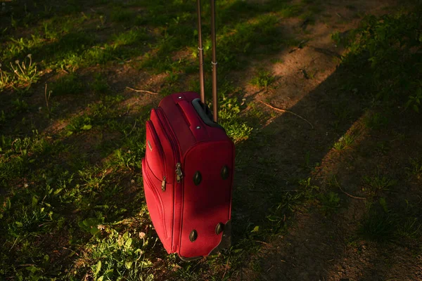 Tourist cabin trolley left in the green grass