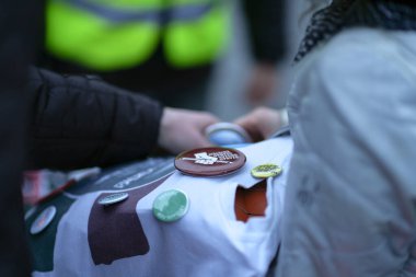 Chest badges for sale from a street vendor in a pillow