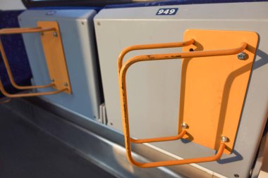 Bicycle racks on a train separated by a shadow