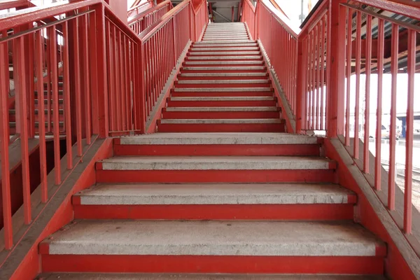 Red stairs leading up to an overpass