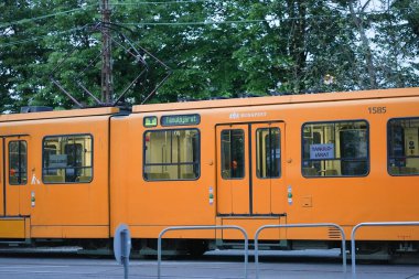 Middle part of an old tram passing in the suburban area of a city