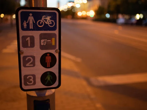 Traffic light sings at night in the city