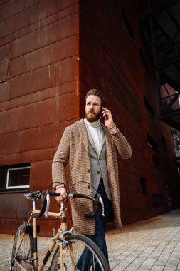 Bisikletli genç adam işe gidiyor. Müdürü arıyorum. Modern bir iş alanında yaratıcı bir iş adamı..