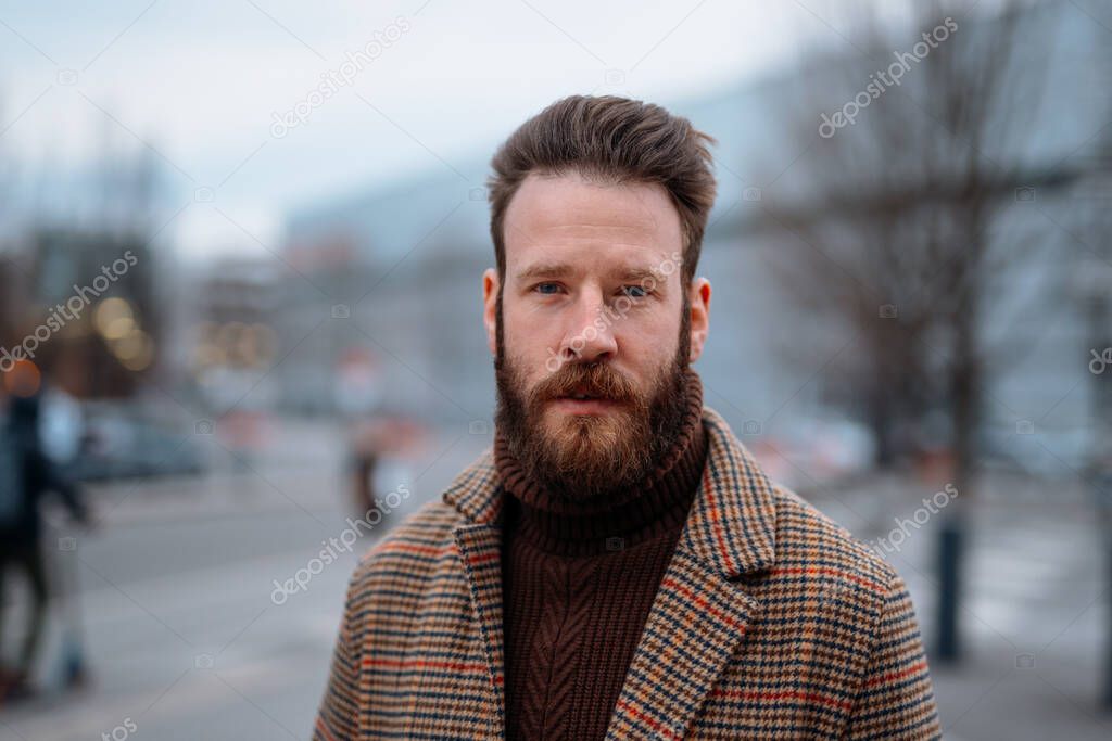 Business portrait of standing man in outdoor. Looking to camera