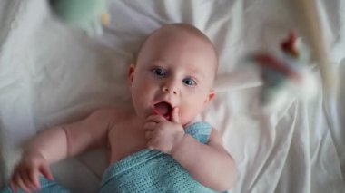 Küçük tatlı causian oğlan, kameraya gülümsüyor, çocuk oyuncağa bakıyor ve mutlu oluyor.. 