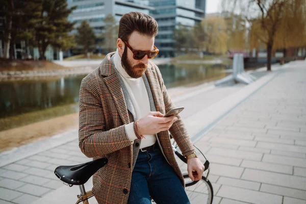 A kreatív igazgató mobiltelefont használ. Férfi álló mellett kerékpár okostelefon. — Stock Fotó