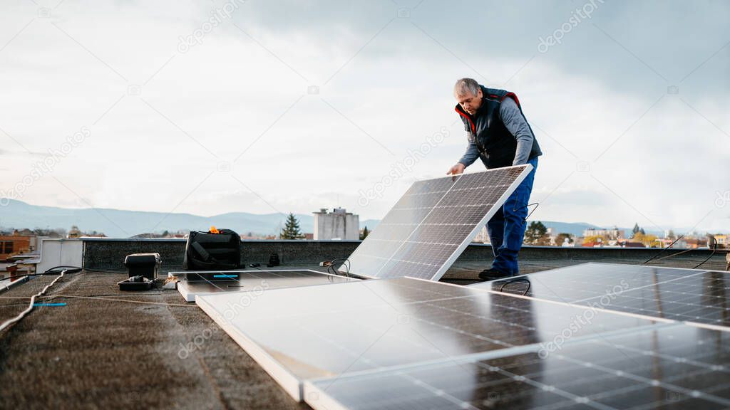 Man installing solar photovoltaic panel system. Banner, Copy space. Eco concept alternative energy