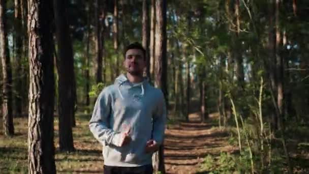 Po záběru běžce ve sportovním oblečení běží lesem. Ranní rutina — Stock video