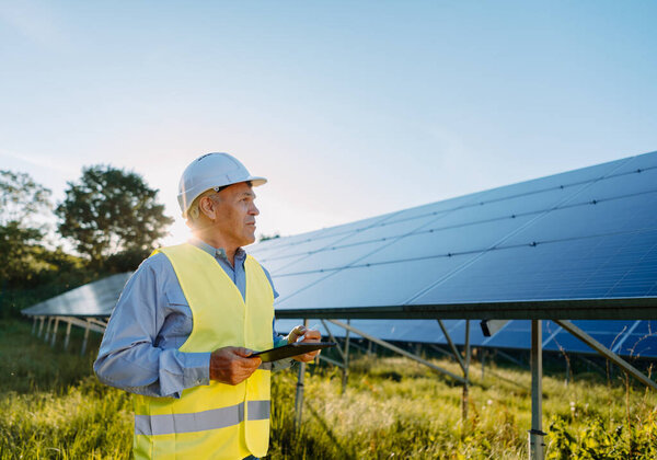 Male Engineer Using Tablet Inspect Solar Panels Eco Energy Concept Stock Photo