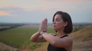 Abdominal breathing. Woman practicing belly breathing with namaste gesture for good relaxation. Breath awareness yoga exercise. Meditation for body, mind and emotions. Spiritual practice