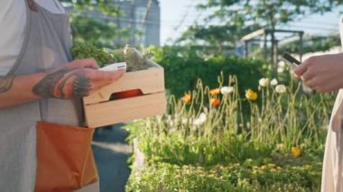 Woman paying by credit card in florist garden shop. Payments concept. High quality 4k footage