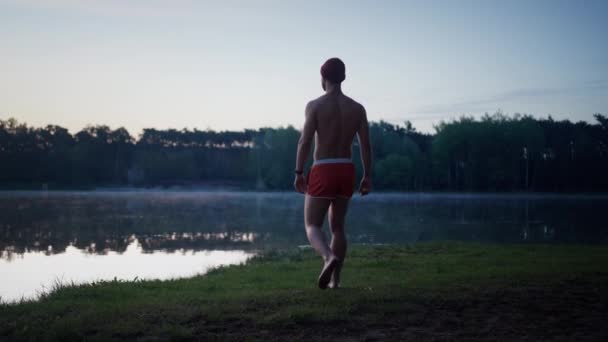 Back View Good Looking Man Swim Shorts Going Lake Grass — Video