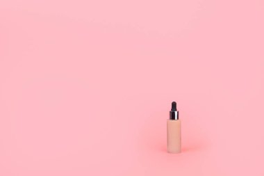 Pembe bir arka plan üzerine kurulmuş. Profesyonel makyaj için BB kremi, yüze başvurmak için göz damlası. Kozmetik kadın aksesuar, sıvı sıvı. Konsepti uydur