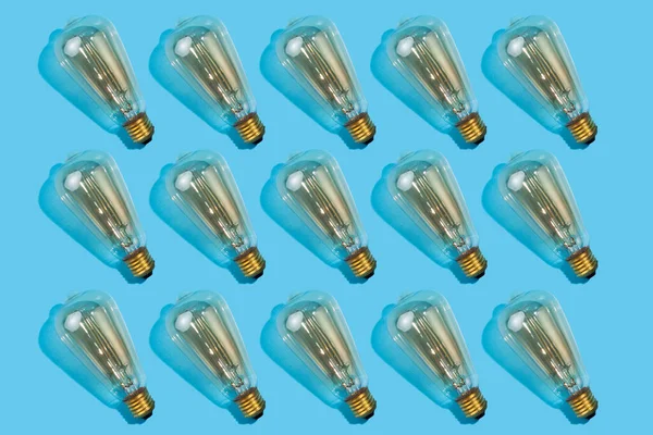 Close Pattern Edison Lamps Isolated Blue Background Energy Efficiency Concept — Stock Photo, Image