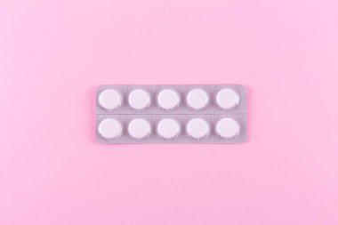 Medicines in packaging on a pink background. Flatlay. women's health, treatment, therapy, contraception, healthcare, painkillers, antidepressants, vitamins