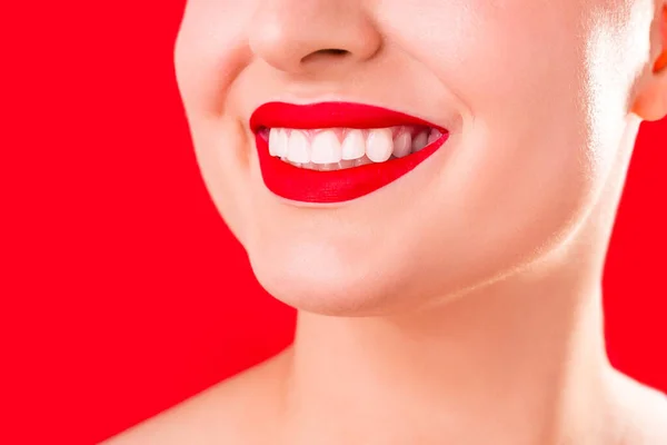 Teeth whitening. Healthy white smile close up. Beauty woman with perfect smile- lips and teeth. Beautiful Model Girl with red lips isolated on white background. Perfect ski