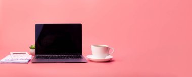Top view photo of white calculator, cup of coffee and grey laptop on isolated pink background. Flatlay, concept freelance, rest and work place