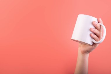 Photo of white cup coffee in hand isolated on pink background. Banner design. Cup of tea