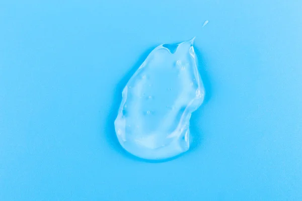 Smear Cosmetology Transparent Product Face Treatment Drop Cream Blue Background — Stock fotografie