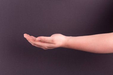 male hand on dark black background. Fashionable spring summer mockup. copyspace 