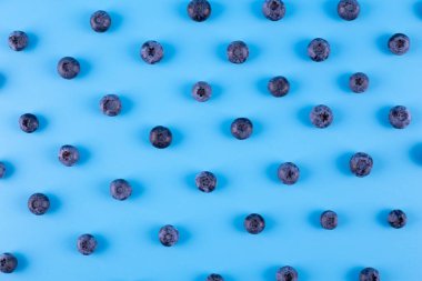 Blueberry isolated on blue background. Blueberries background. Healthy, natural fruit. Vegan and vegetarian concept. Summer healthy food. 