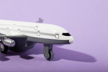 Oyuncak uçağın yakın planında mor bir nesne var. Model uçak kapatın. Tatil ve iş seyahati kavramı. asgari konsept