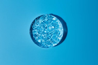 Nemlendirilmiş jel ile şeffaf mavi arka planda boş beyaz daire. Ürün sunumu için soyut doğa arka planı. Düz uzanmış kozmetik maketi, boşluğu kopyala