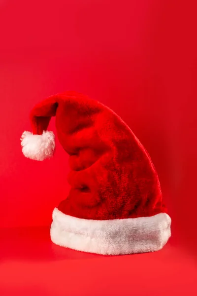 Santa Claus red hat isolated on red background. Happy new year concept, flatlay, copyspac