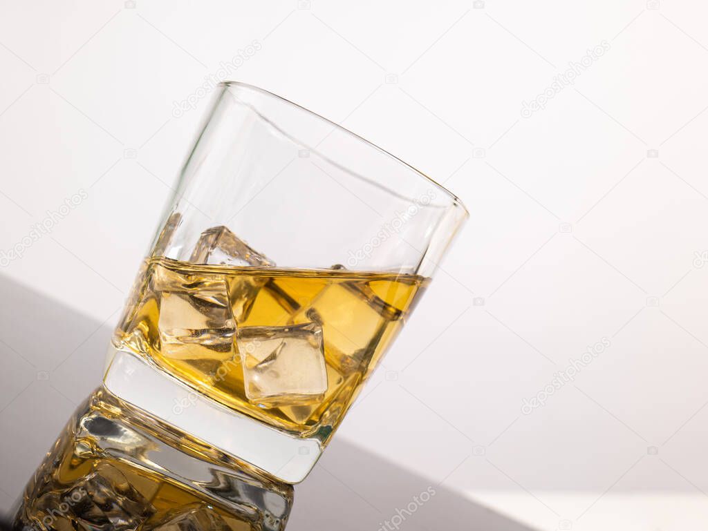 glass for liquor Translucent elements made of glass are placed on a tilted table. empty objects isolated on white background