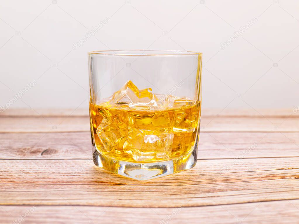 glass for liquor Translucent elements made of glass are placed on a wooden table. empty objects isolated on white background