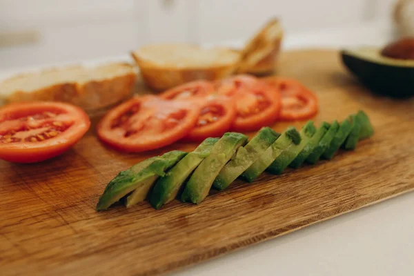 toast with avocado in the kitchen Cooking breakfast