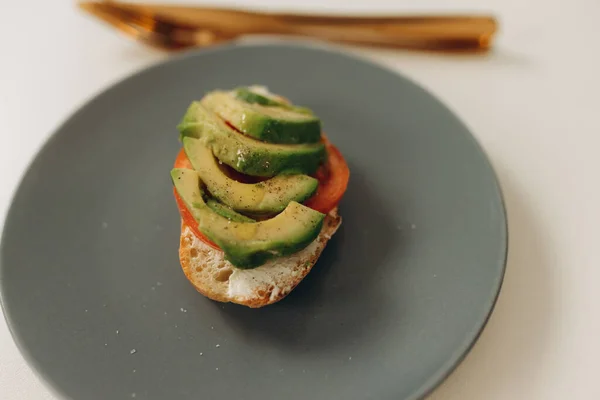 toast with avocado in the kitchen Cooking breakfast