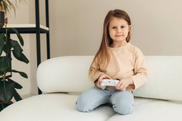 Маленька Дівчинка Грає Відеоігри Тримаючи Ігровий Контролер Сидячи Дивані Вітальні — стокове фото