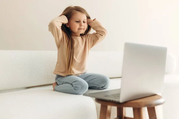 Маленька Дівчинка Сидить Дивані Дивиться Екран Ноутбука — стокове фото