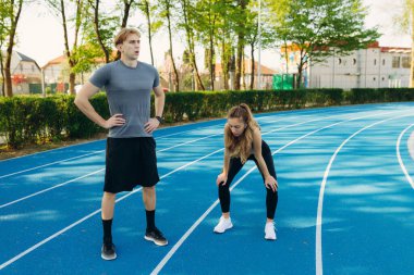 Yorgun sporcular koşudan sonra dinleniyor