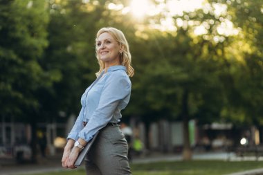 Portrait of a successful mature businesswoman holding a laptop. Women of the 50s. The concept of work. Freelance. Success