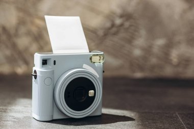 Karanlık arka planda eski fotoğraf makinesi ve fotoğraf kartları. Polaroid kamera